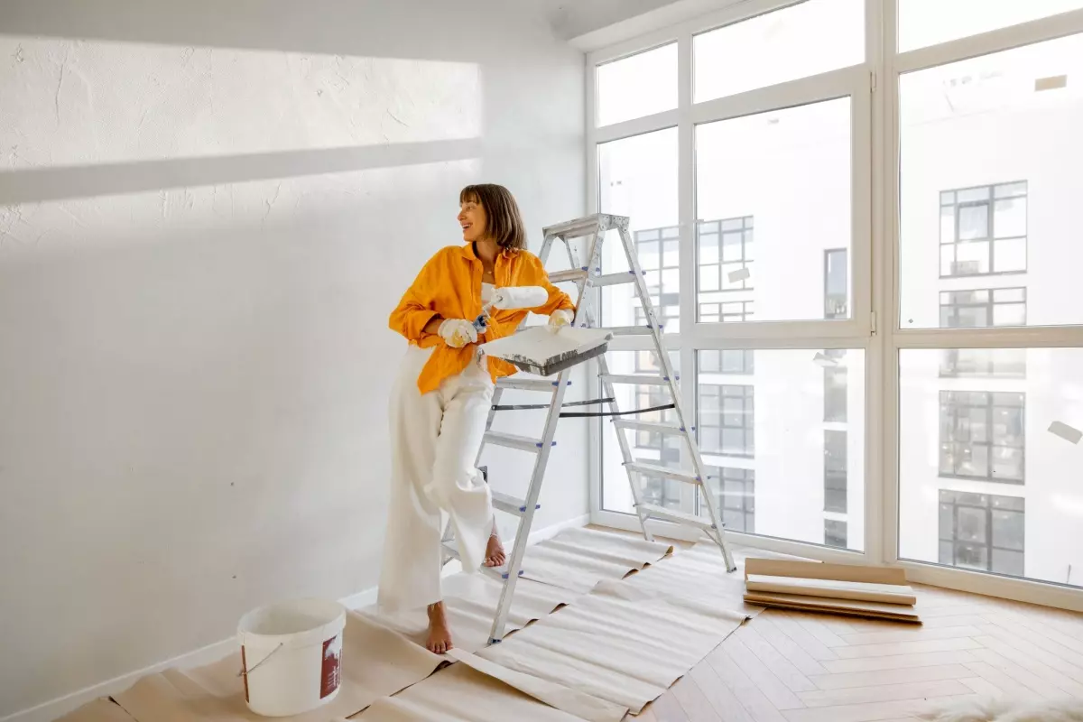 woman painting wall preparing for selling inherited property