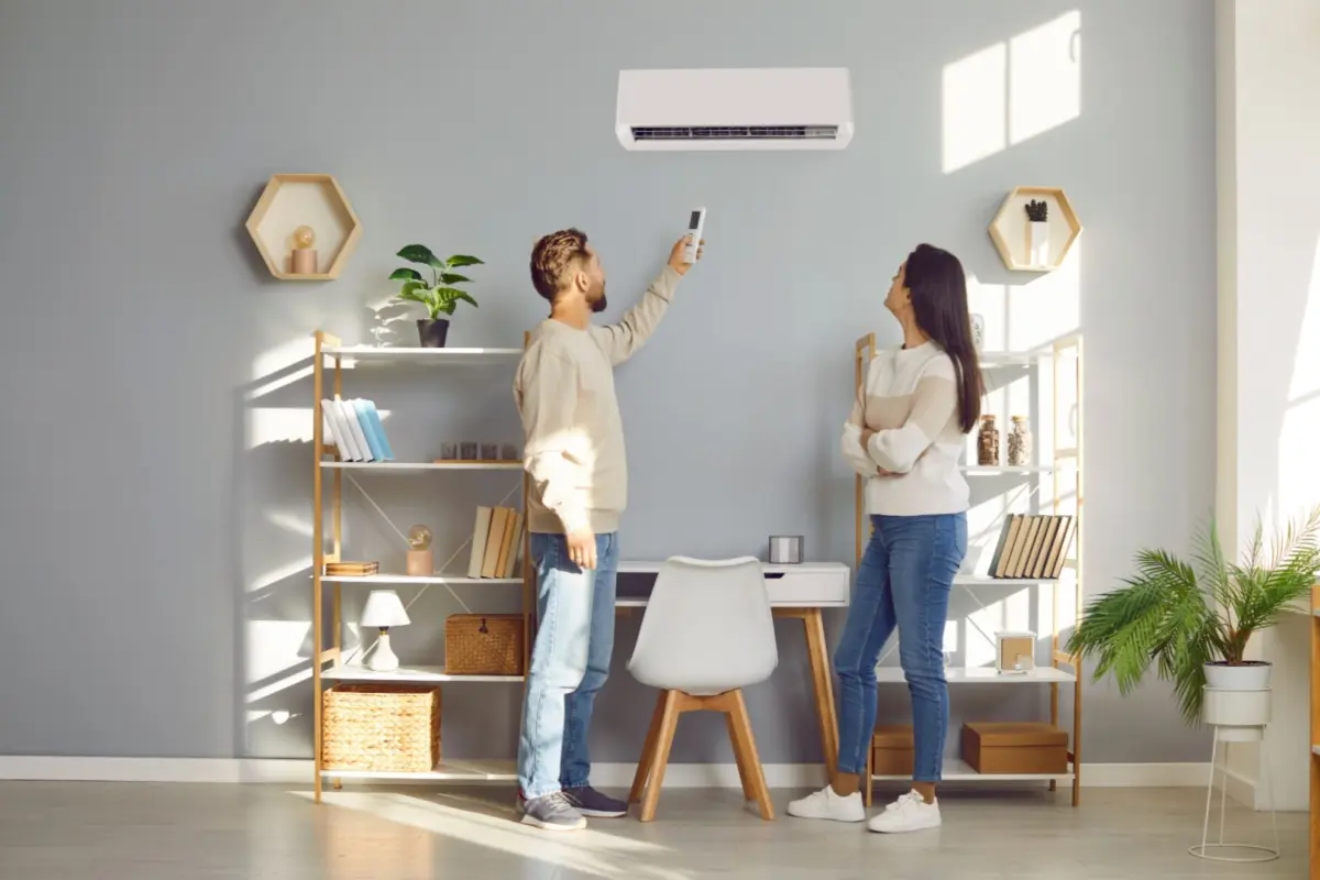 Couple setting up their newly installed air conditioner 