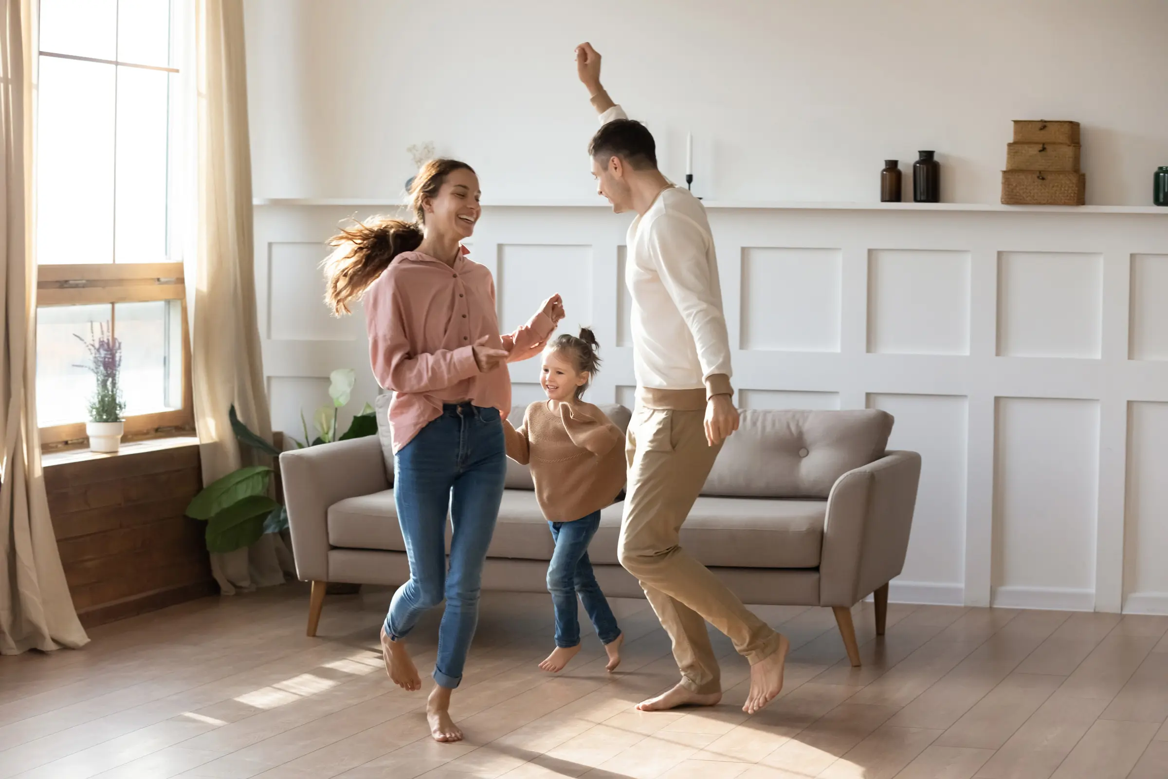 family dancing in a newly renovated living room