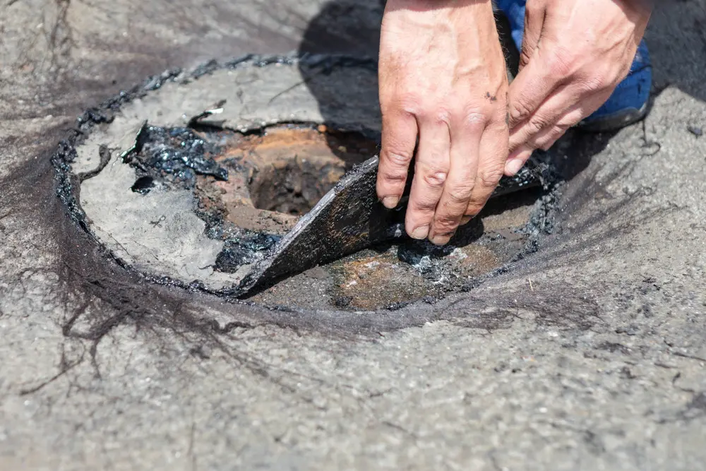 Deteriorated roofing layers exposed during a flat-roof tear-off