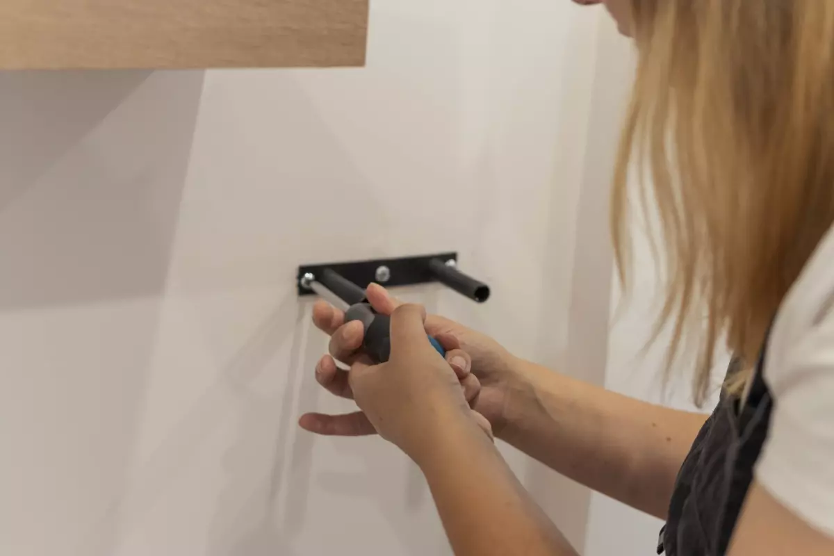 Woman installing a floating desk