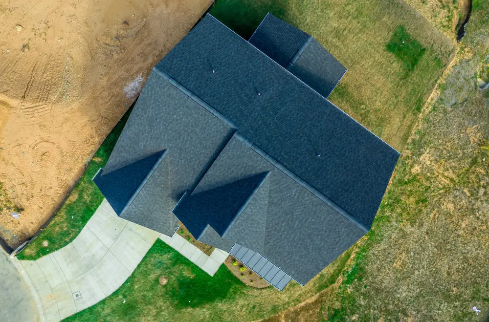 Aerial view of a residential hip-and-valley roof with multiple sloping sections