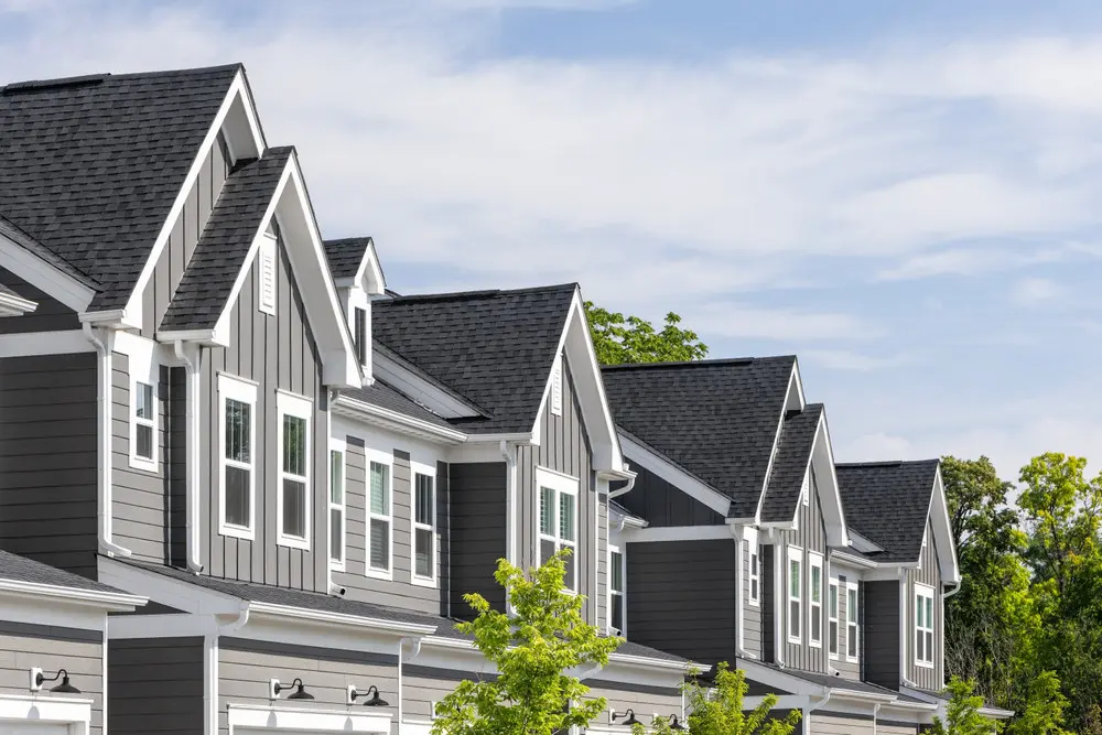 Row of townhomes with coordinated roofing, siding, and exterior colors