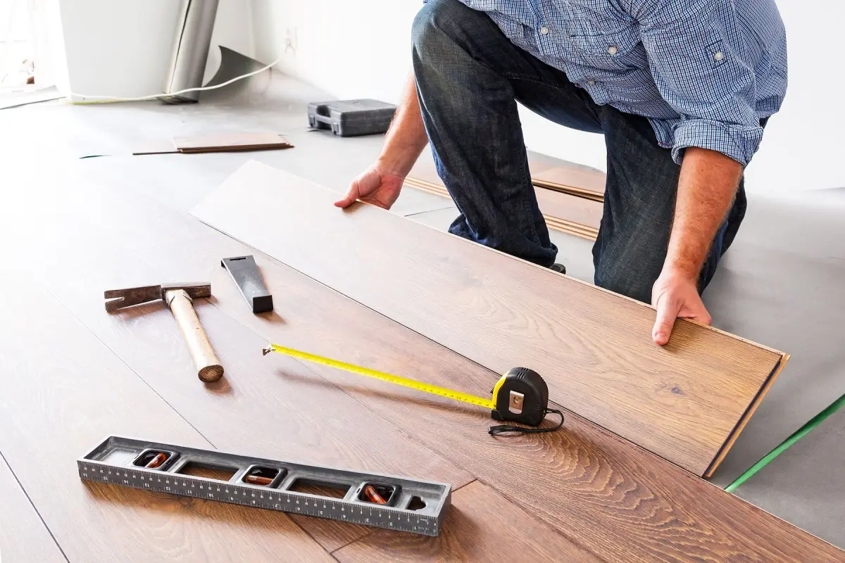 A floor repair contractor installing a floating floor 