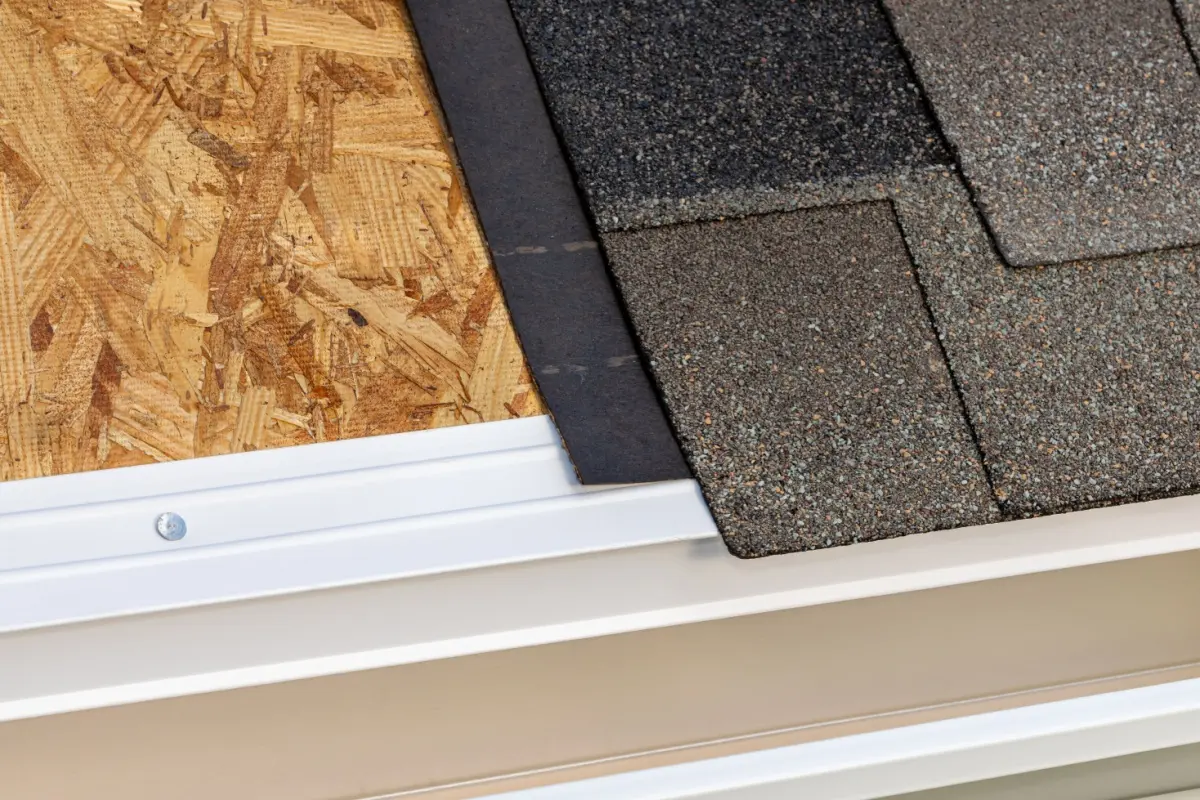 Drip edge installed to roof under asphalt shingles.