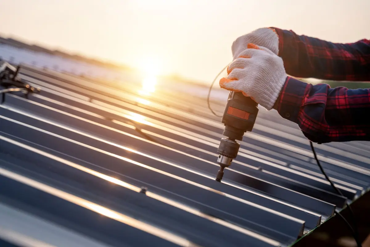 Roofer installing a metal roof